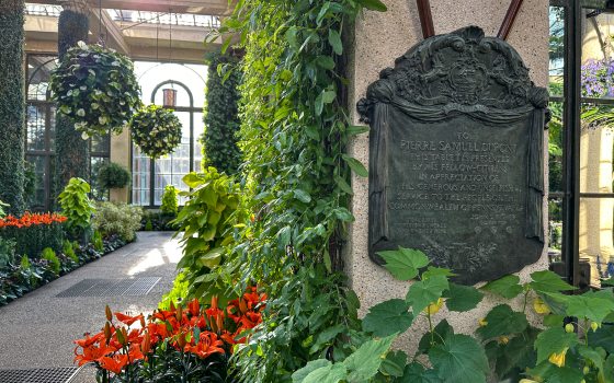 A bronze plaque with text in the Longwood Conservatory.